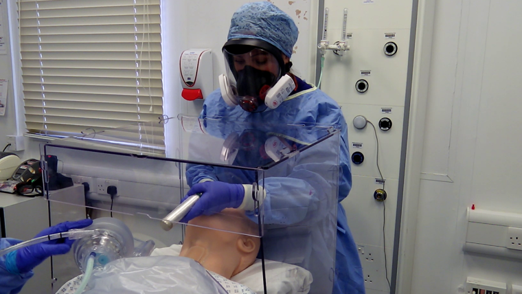 Protective perspex shield being used during intubation